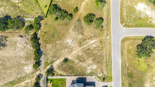 an aerial view of a residential houses with outdoor space