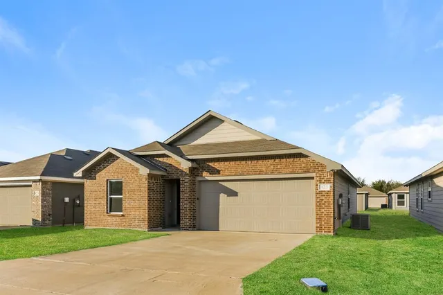 a front view of a house with yard and garage