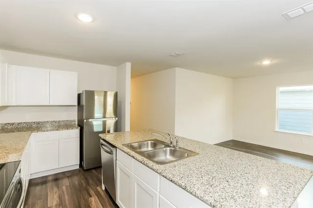 a kitchen with a sink stove and refrigerator