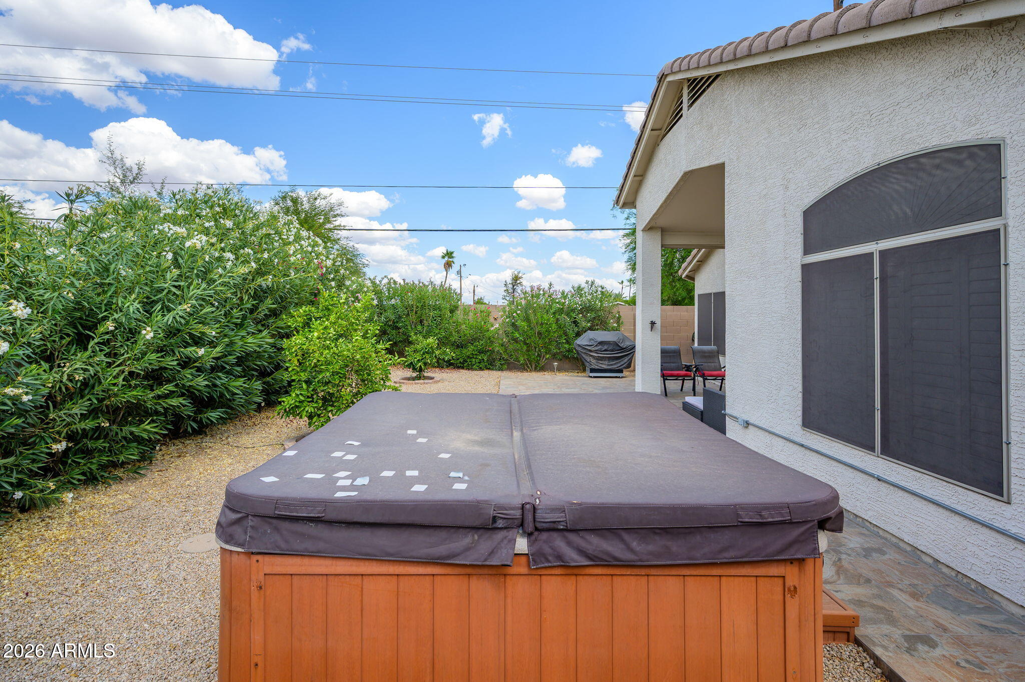 3136 East Roveen Avenue Phoenix, AZ 85032 - Photo 34 of 38 a backyard of a house with table and chairs
