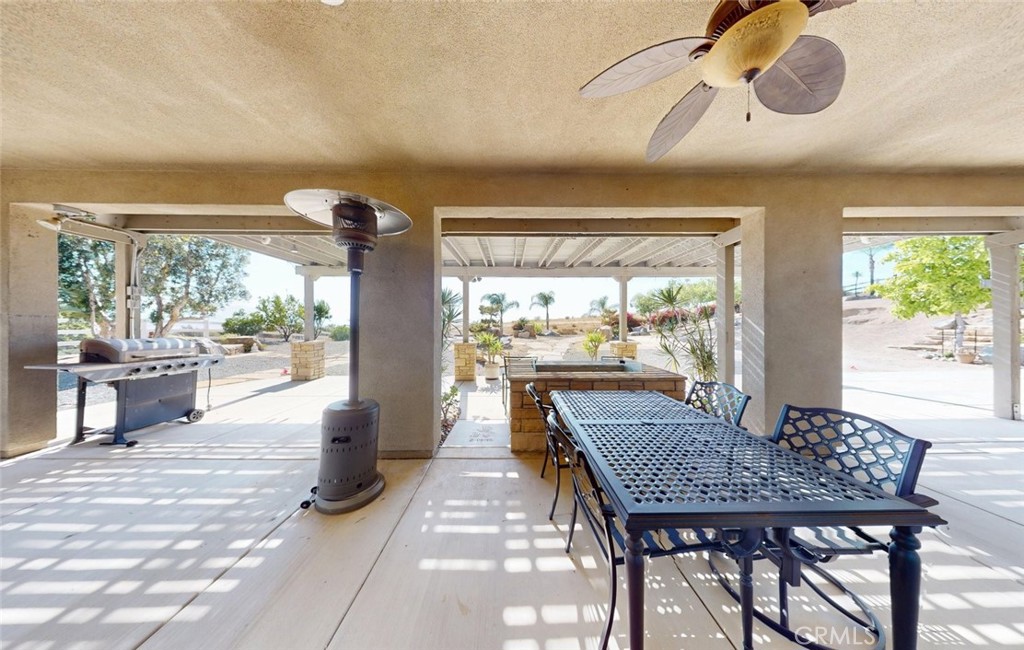 17465 Fairbreeze Court Riverside, CA 92504 - Photo 15 of 30 a dining room with furniture and a floor to ceiling window