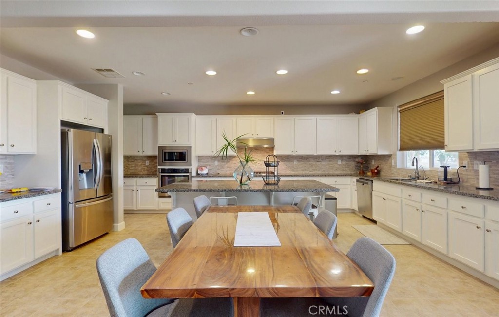 17465 Fairbreeze Court Riverside, CA 92504 - Photo 19 of 30 a large kitchen with a table and chairs