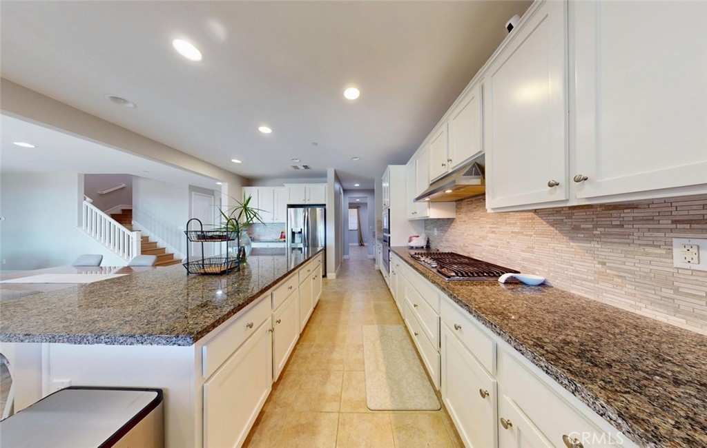 17465 Fairbreeze Court Riverside, CA 92504 - Photo 21 of 30 a large kitchen with stainless steel appliances granite countertop a lot of counter space