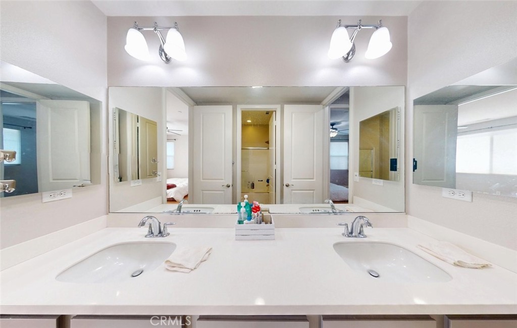 17465 Fairbreeze Court Riverside, CA 92504 - Photo 22 of 30 a bathroom with a double vanity sink and a mirror