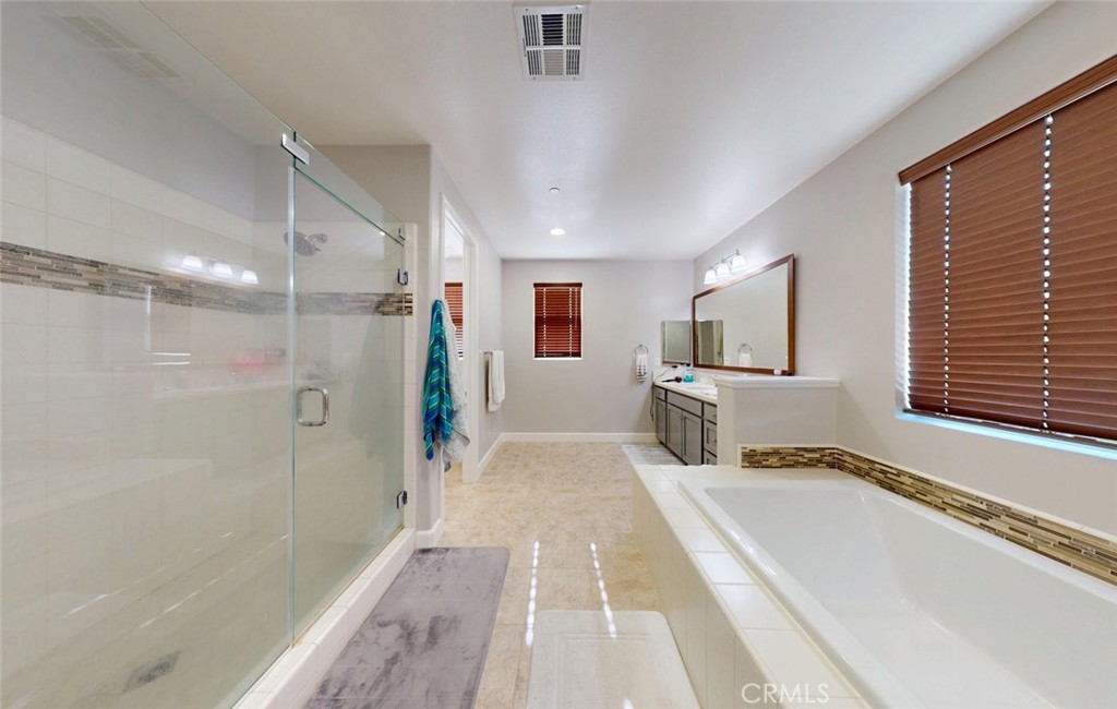 17465 Fairbreeze Court Riverside, CA 92504 - Photo 25 of 30 a spacious bathroom with a tub and a shower