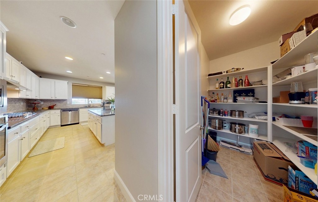 17465 Fairbreeze Court Riverside, CA 92504 - Photo 27 of 30 a view of living room kitchen and stainless steel appliances