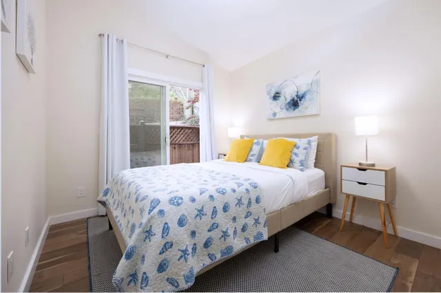 a bedroom with a bed and a large window