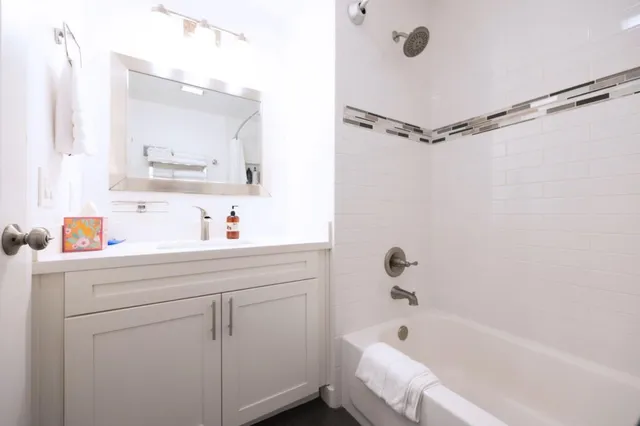 a bathroom with a bathtub and a sink