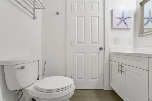a white toilet sitting next to a bathroom sink