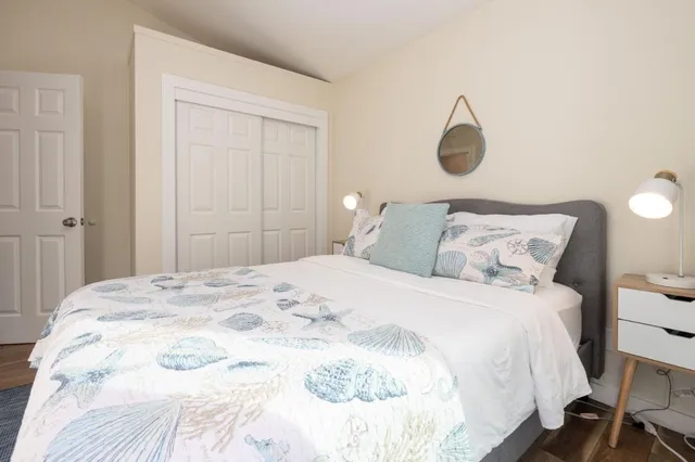 a bedroom with a bed and a lamp