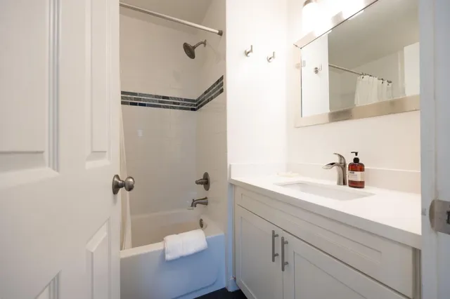 a bathroom with a shower sink and toilet