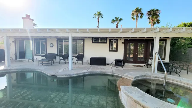 a kitchen with a sink a counter and chairs
