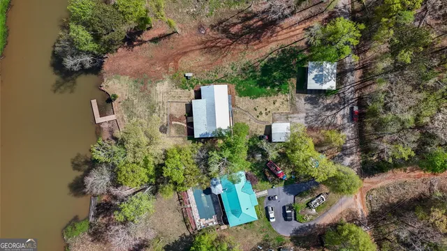 an aerial view of a house with a yard and garden