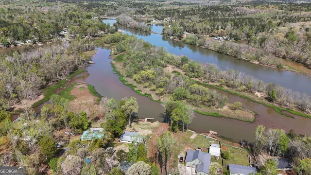 an aerial view of a houses with outdoor space and lake view
