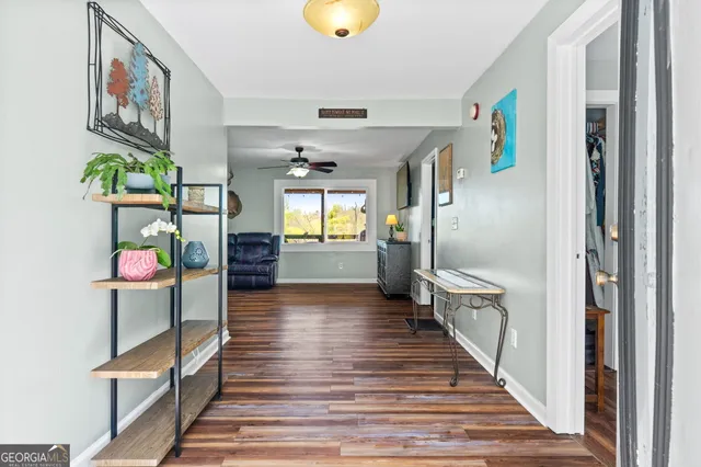 a view of entryway and hall with wooden floor