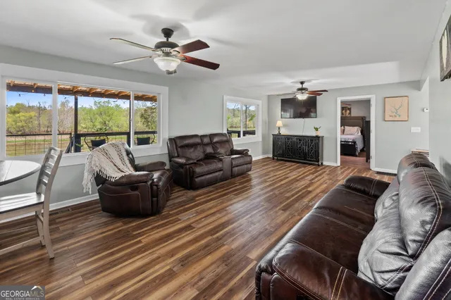 a living room with furniture fireplace and a large window