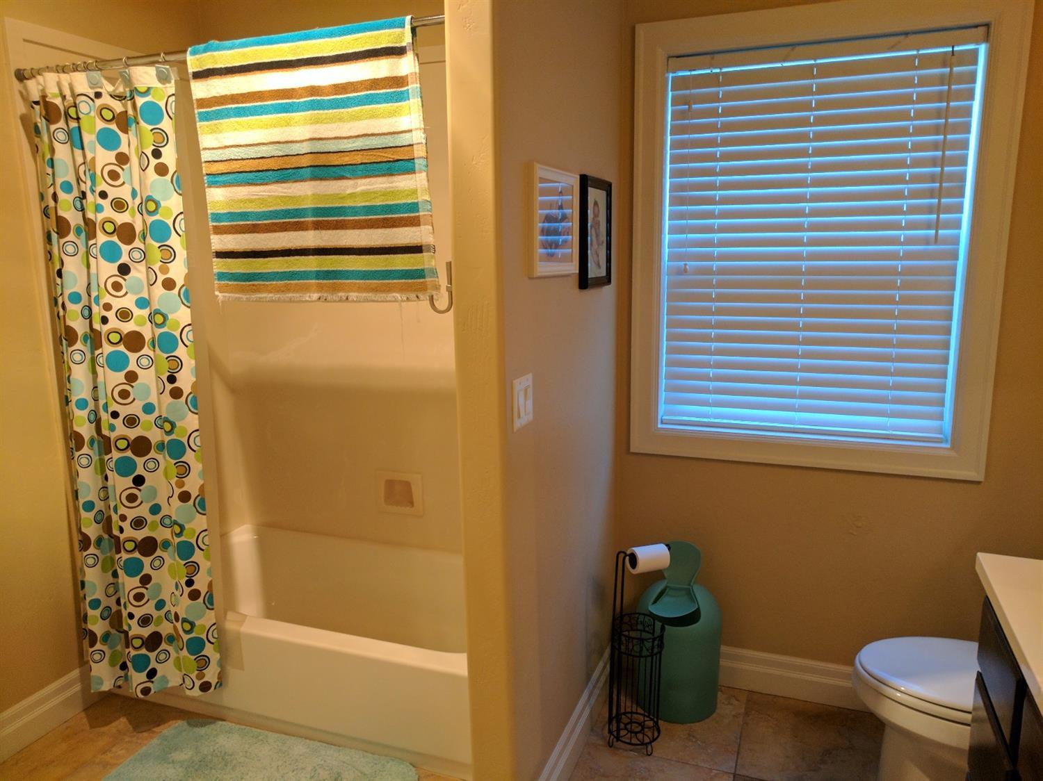 815 Buck Point Street Central Point, OR 97502 - Photo 9 of 15 a bathroom with a window and a shower