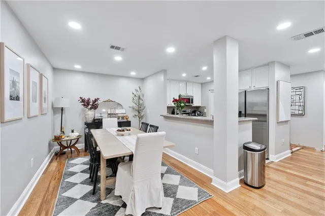 a large kitchen with a table and chairs