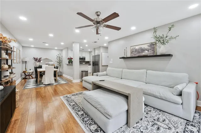a living room with furniture and kitchen view