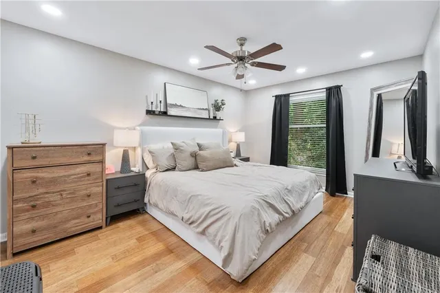 a bedroom with a large bed and a chandelier