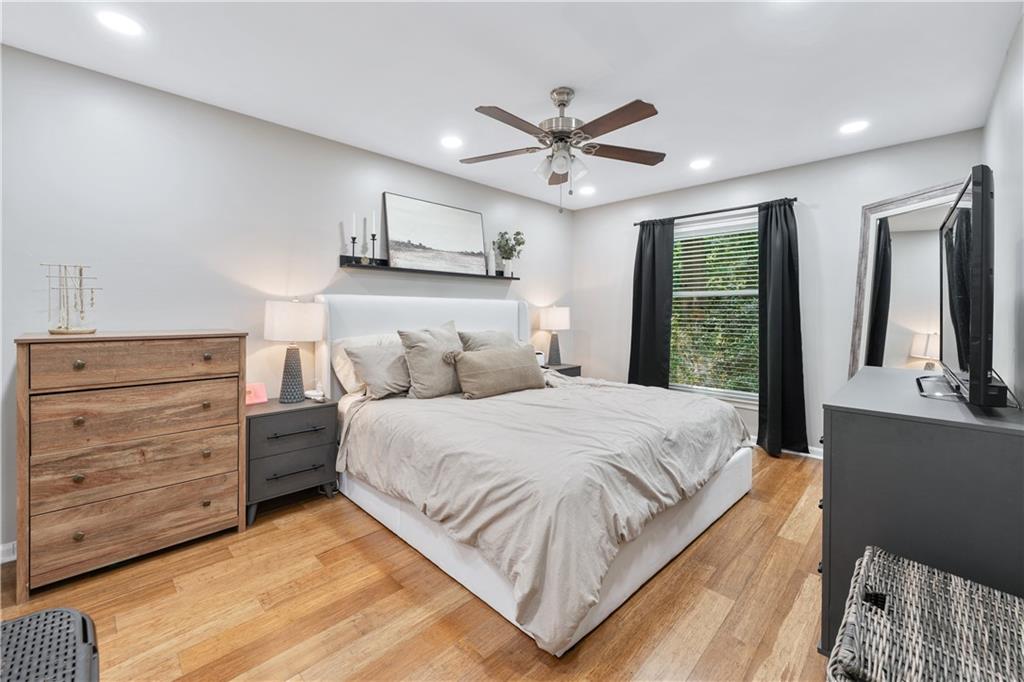3650 Ashford Dunwoody Road Northeast, Unit 1026 Atlanta, GA 30319 - Photo 22 of 28 a bedroom with a large bed and a chandelier