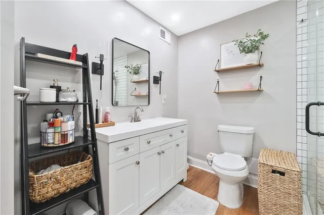 a bathroom with a sink mirror vanity and toilet