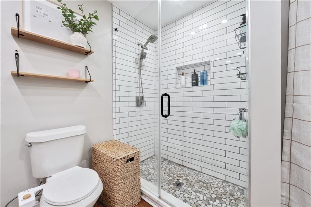 3650 Ashford Dunwoody Road Northeast, Unit 1026 Atlanta, GA 30319 - Photo 25 of 28 a bathroom with a toilet and shower