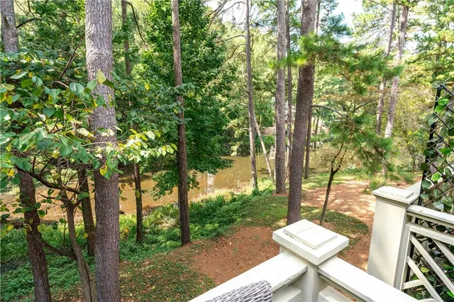 a backyard of a house with table and chairs under an umbrella