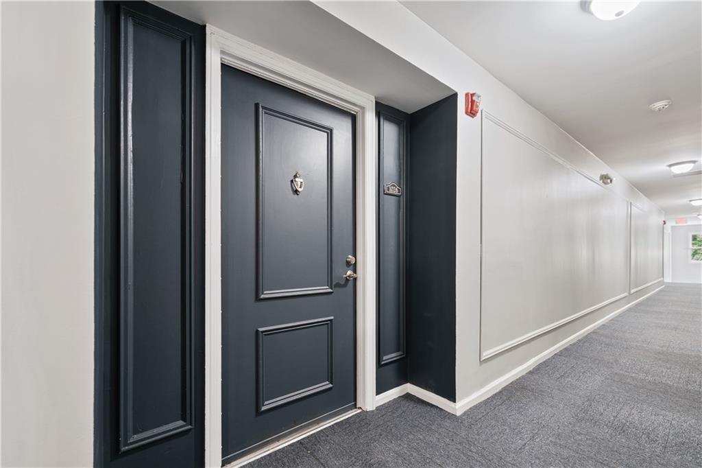 3650 Ashford Dunwoody Road Northeast, Unit 1026 Atlanta, GA 30319 - Photo 8 of 28 a view of hallway with cabinets