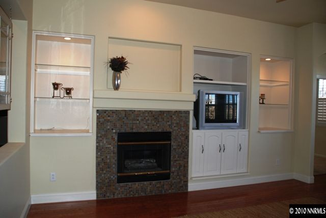 10201 Wolf Ridge Way Reno, NV 89521 - Photo 3 of 11 a living room with a fireplace with wooden floor