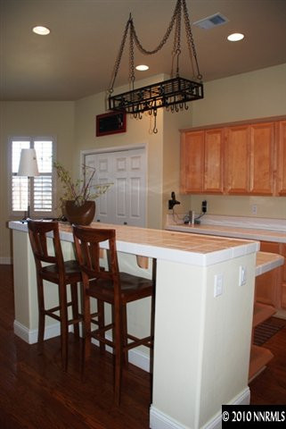 10201 Wolf Ridge Way Reno, NV 89521 - Photo 4 of 11 a kitchen with a dining table and chairs