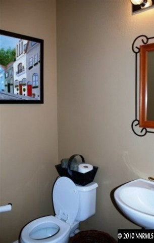 10201 Wolf Ridge Way Reno, NV 89521 - Photo 6 of 11 a bathroom with a toilet sink and mirror