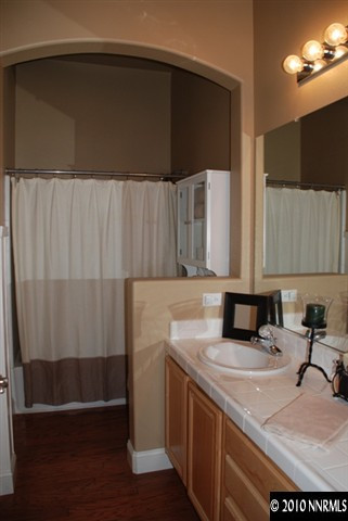 10201 Wolf Ridge Way Reno, NV 89521 - Photo 8 of 11 a bathroom with a sink and a mirror