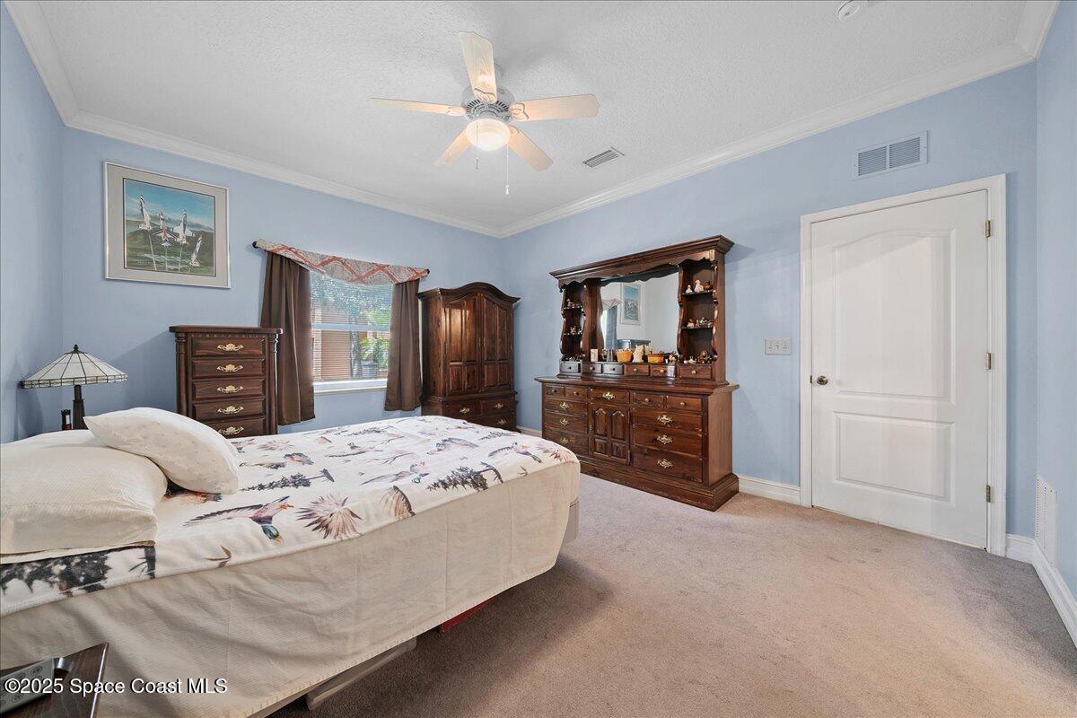2097 Hidden Grove Lane, Unit 105 Merritt Island, FL 32953 - Photo 12 of 27 a bed room with a bed and a television