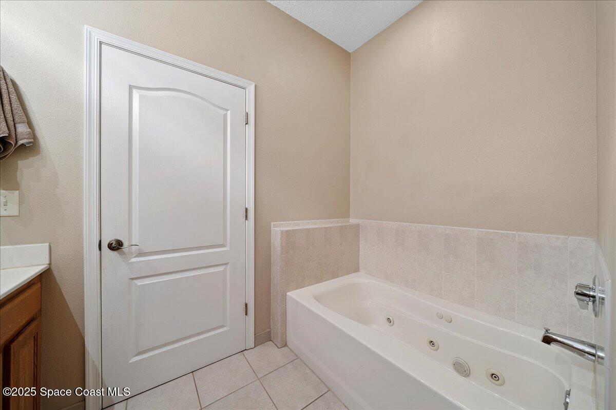 2097 Hidden Grove Lane, Unit 105 Merritt Island, FL 32953 - Photo 14 of 27 a bathroom with a bathtub and a shower