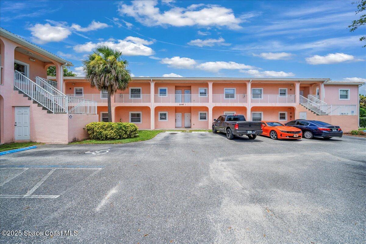 2097 Hidden Grove Lane, Unit 105 Merritt Island, FL 32953 - Photo 25 of 27 a car parked in front of a building
