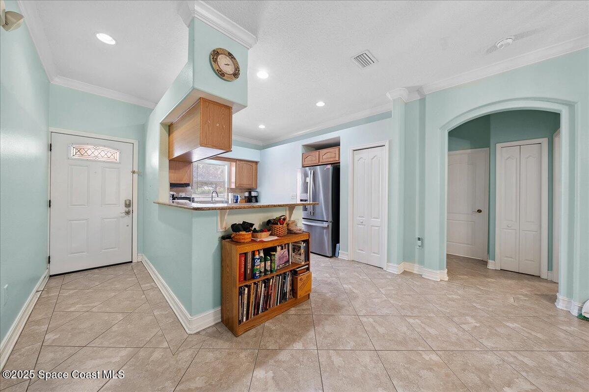 2097 Hidden Grove Lane, Unit 105 Merritt Island, FL 32953 - Photo 6 of 27 a view of kitchen with stainless steel appliances kitchen island refrigerator and stove