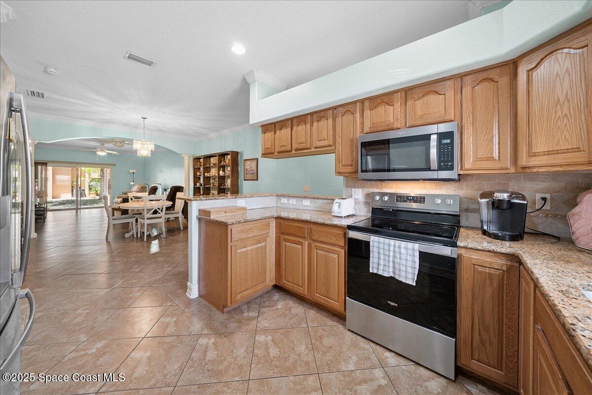 2097 Hidden Grove Lane, Unit 105 Merritt Island, FL 32953 - Photo 7 of 27 a kitchen with a sink cabinets and stainless steel appliances