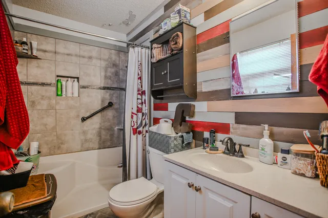 a bathroom with a sink toilet and shower