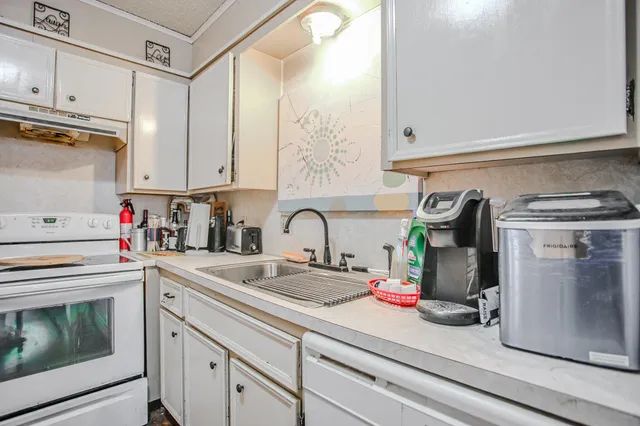 a kitchen with a sink and cabinets