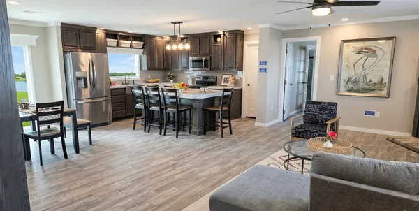 a livingroom with dining area a refrigerator a dining table and chairs