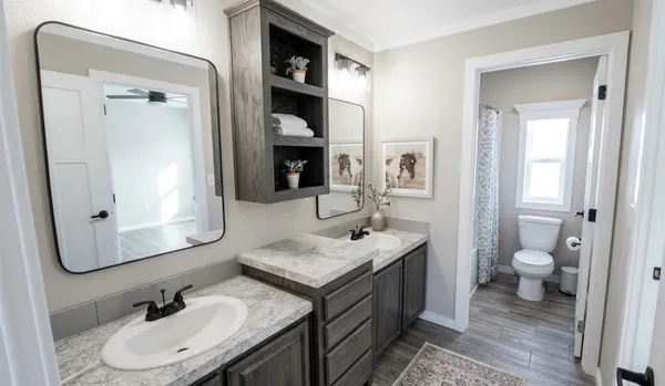 a bathroom with a granite countertop sink a toilet and a mirror