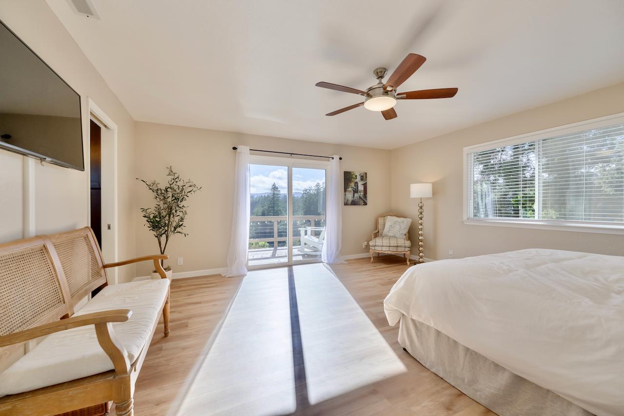 155 Rabbits Run Road Santa Cruz, CA 95060 - Photo 51 of 113 a bedroom with a large bed and a chandelier fan