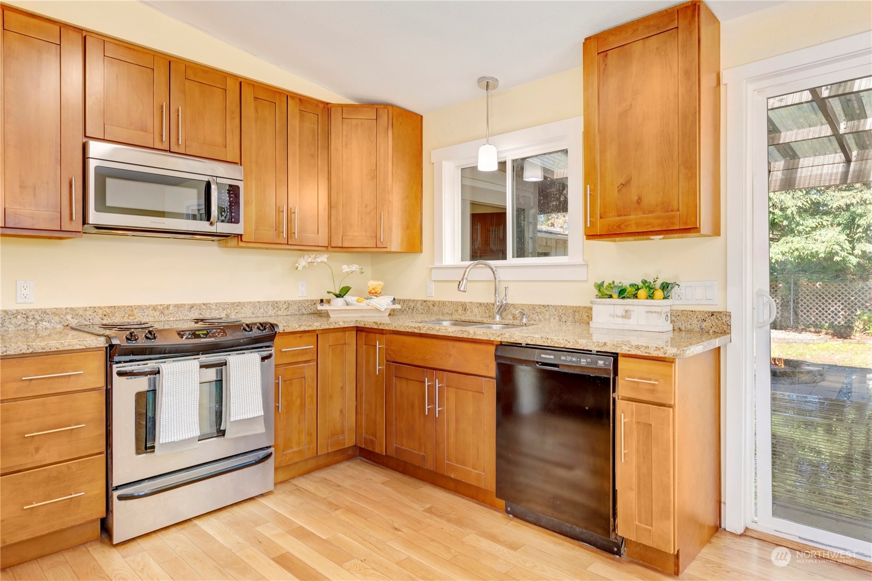 11404 Southeast 169th Street Renton, WA 98055 - Photo 8 of 25 a kitchen with stainless steel appliances granite countertop a stove a sink and a microwave