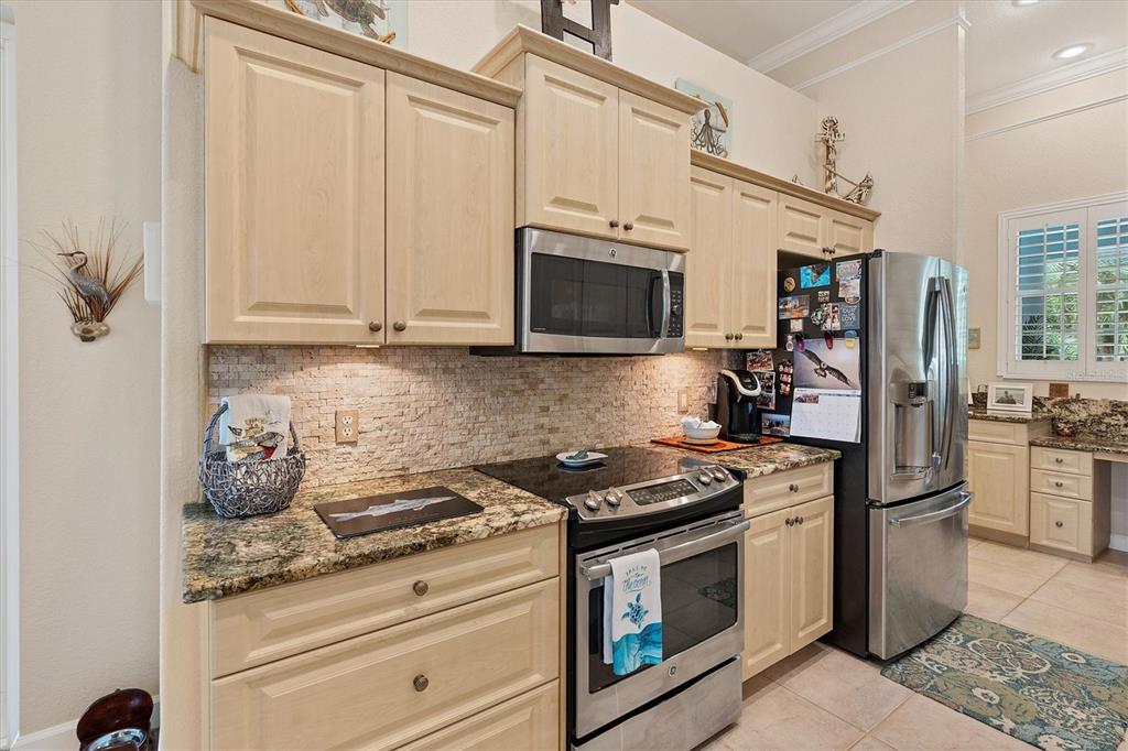 200 Capstan Drive Placida, FL 33946 - Photo 42 of 86 a kitchen with stainless steel appliances granite countertop a stove a refrigerator and a microwave
