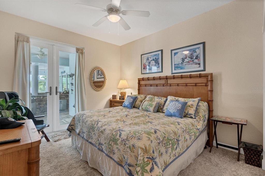 200 Capstan Drive Placida, FL 33946 - Photo 45 of 86 a bedroom with a large bed and a chandelier