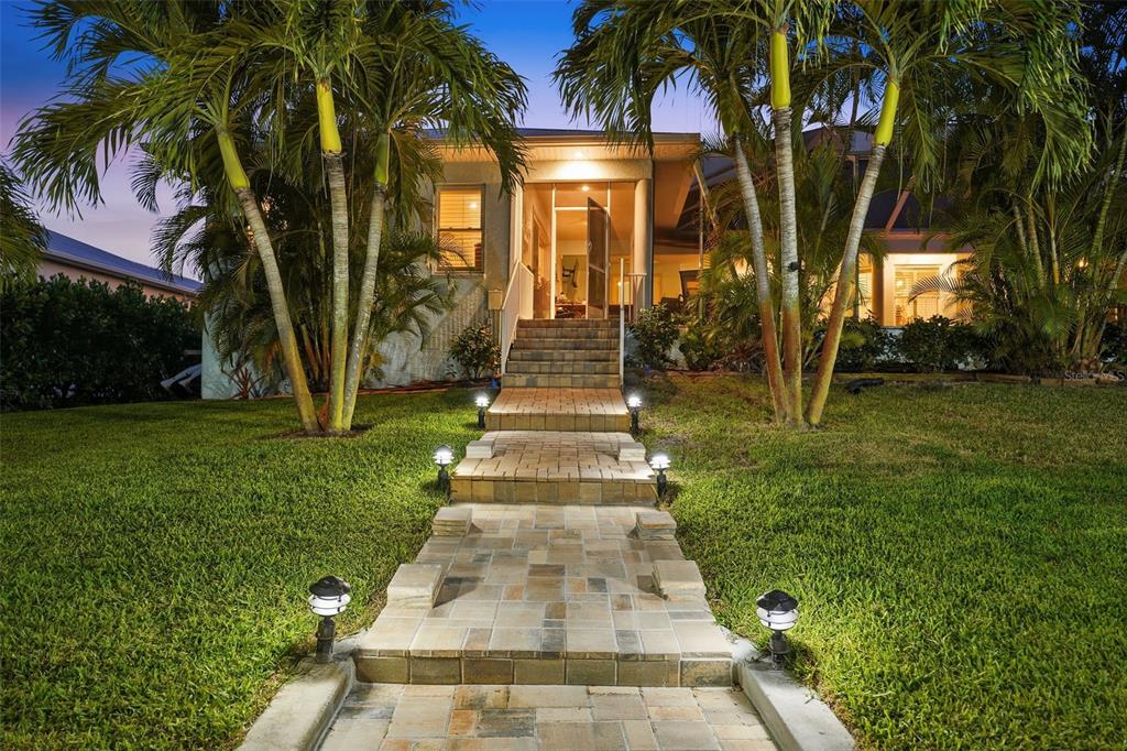200 Capstan Drive Placida, FL 33946 - Photo 48 of 86 a front view of a house with a garden and trees