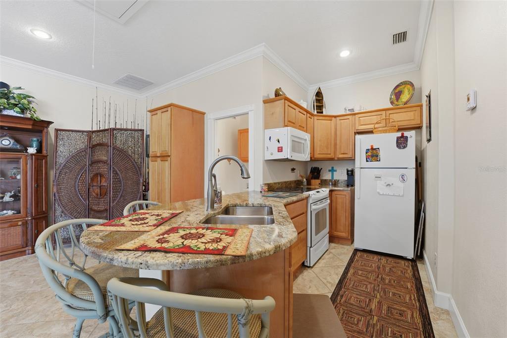 200 Capstan Drive Placida, FL 33946 - Photo 70 of 86 a kitchen with stainless steel appliances granite countertop a sink a stove a refrigerator and cabinets