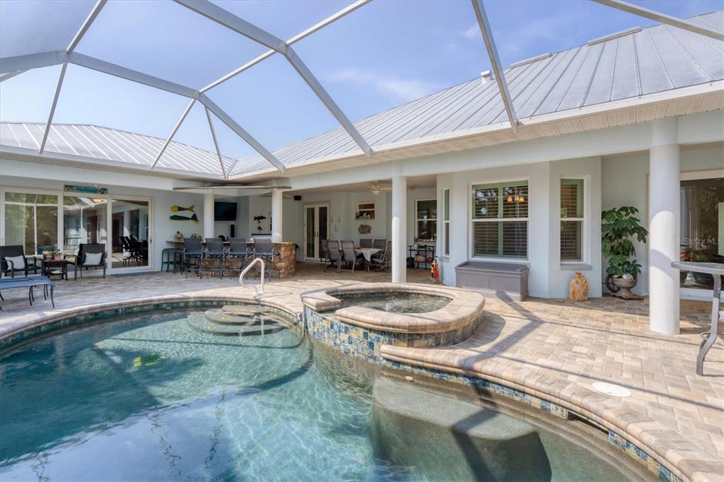 200 Capstan Drive Placida, FL 33946 - Photo 10 of 86 a view of a patio with couches table and chairs under an umbrella