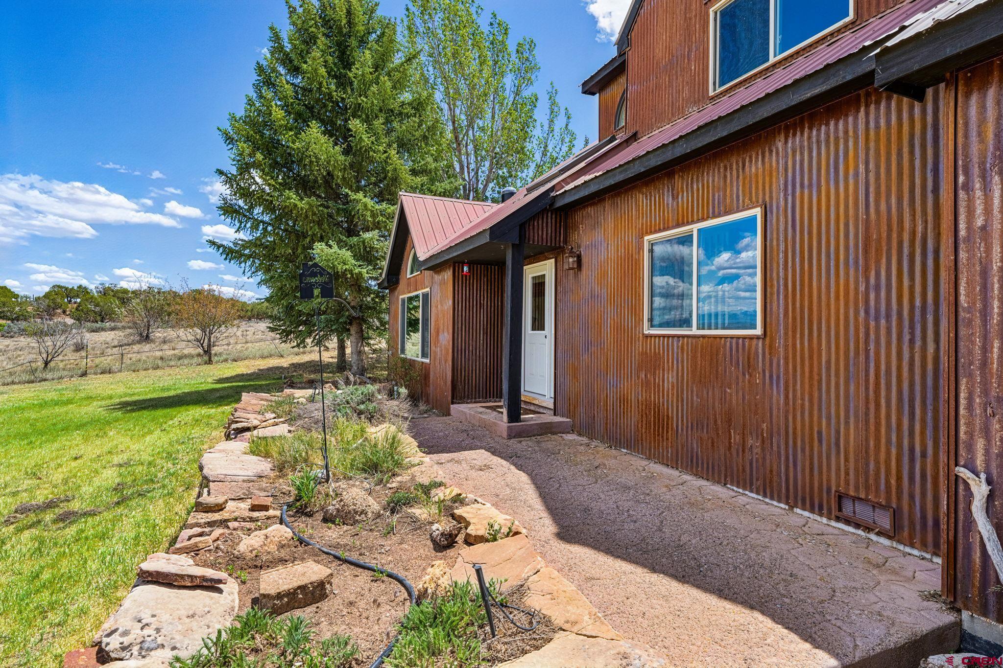 22480 Rd L Cortez, CO 81321 - Photo 27 of 44 a front view of a house with garden